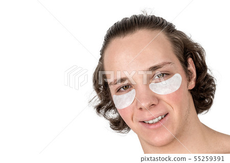 Portrait of young man with collagen patches under 55259391