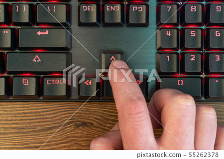 finger presses the up arrow 55262378