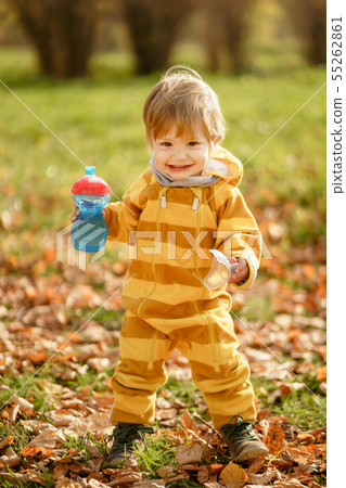 Happy little boy with water bottle playing in the 55262861