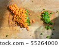 Chopped vegetables and vegetables like paprika and carrots are on the chopping board. Scene preparing food ingredients 55264000