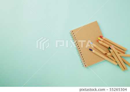Crayon With a notebook on blue 55265304