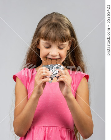 Teen girl with pleasure bites chocolate Teen girl with pleasure bites chocolate 55265423