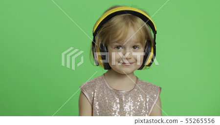 Girl in glossy dress and headphone listening to music. Chroma Key 55265556