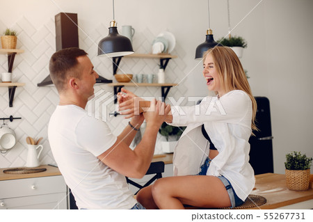 Beautiful couple spend time in a kitchen Beautiful couple spend time in a kitchen 55267731