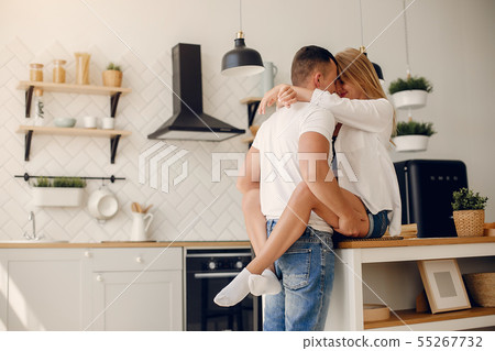 Beautiful couple spend time in a kitchen Beautiful couple spend time in a kitchen 55267732