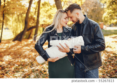 Family with daughter in a autumn park Family with daughter in a autumn park 55267813