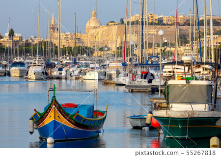Valletta. Traditional Luzzu fishing boat in the harbor. Valletta. Traditional Luzzu fishing boat in the harbor. 55267818