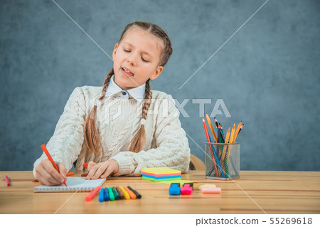 Little blond girl is getting bored of all studying stuff. 55269618