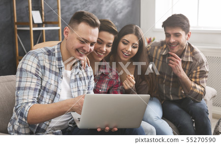 Laughing friends watching funny video on laptop 55270590