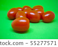Red tomatoes on green background. Vegetables 55277571