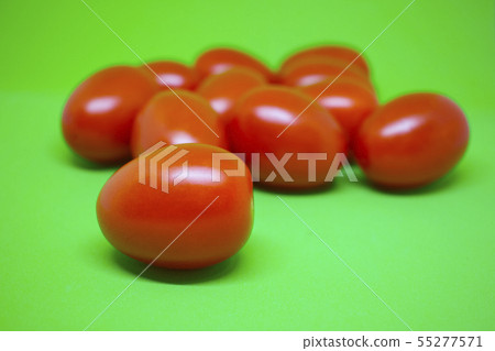 Red tomatoes on green background. Vegetables Red tomatoes on green background. Vegetables 55277571