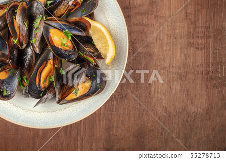 Marinara mussels, moules mariniere, close-up from the top on a rustic background with copyspace Marinara mussels, moules mariniere, close-up from the top on a rustic background with copyspace 55278713