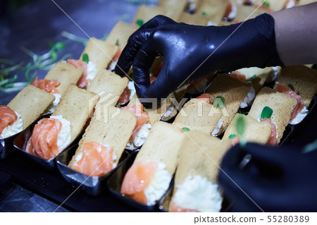 Chef making Norwegian Smoked Salmon Canapes with Cream Cheese. Chef making Norwegian Smoked Salmon Canapes with Cream Cheese. 55280389