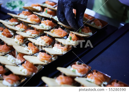 Chef making Norwegian Smoked Salmon Canapes with Cream Cheese. Chef making Norwegian Smoked Salmon Canapes with Cream Cheese. 55280390