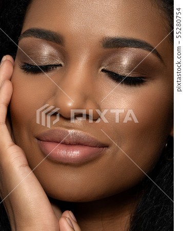 Young beautiful black woman touching her face Young beautiful black woman touching her face 55280754