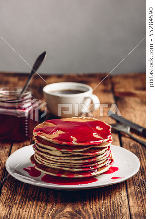 Stack of american pancakes with red berry jam 55284590