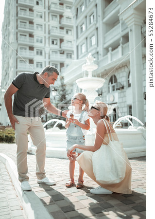 Married couple walking with their little daughter. Married couple walking with their little daughter. 55284673