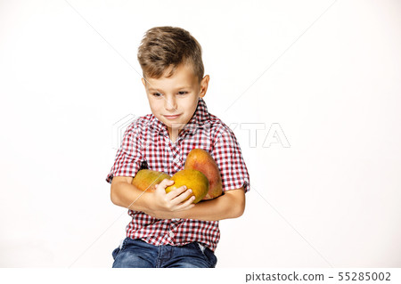 handsome boy in a red shirt with a mango handsome boy in a red shirt with a mango 55285002