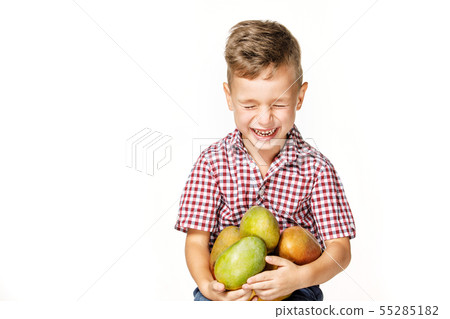 handsome boy in a red shirt with a mango 55285182
