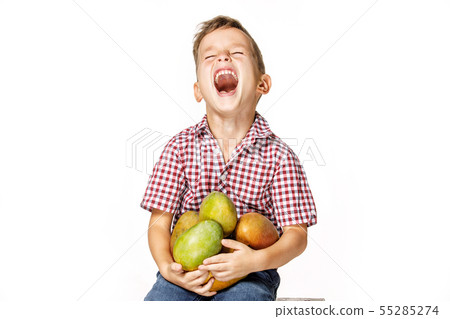 handsome boy in a red shirt with a mango handsome boy in a red shirt with a mango 55285274