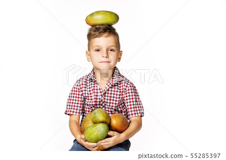 handsome boy in a red shirt with a mango 55285397