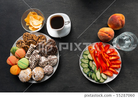 Choosing between junk sweet food and fruits Choosing between junk sweet food and fruits 55287060