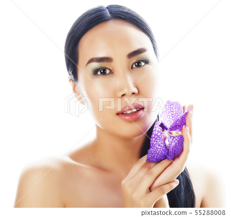 young pretty asian woman with flower purple orchid close up isolated spa, womans day concept 55288008