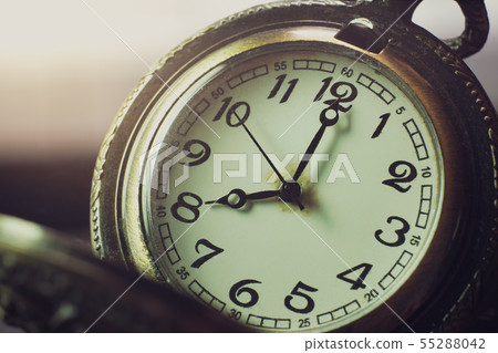 Closeup pocket watch on table and sunlight. At 8 a 55288042