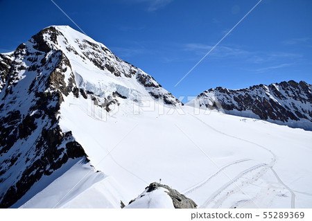 Walking route to Monchsjoch-Hütte walking from the Sphinx Observatory to the snowy fields of the foot of Monch Walking route to Monchsjoch-Hütte walking from the Sphinx Observatory to the snowy fields of the foot of Monch 55289369