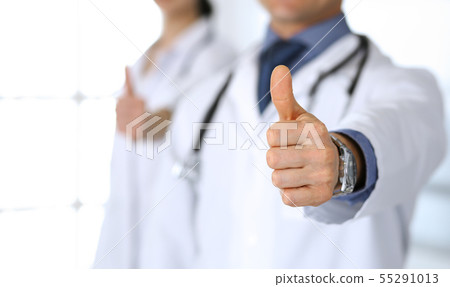Group of doctors showing thumbs up. Perfect medical service in clinic. Happy future in medicine and 55291013