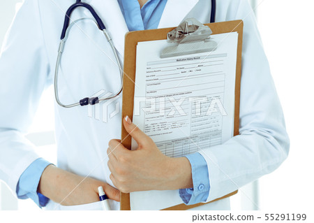 Female doctor using medical form on clipboard closeup. Physicianat work in hospital or clinic Female doctor using medical form on clipboard closeup. Physicianat work in hospital or clinic 55291199