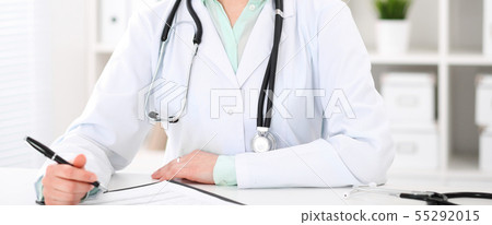 Doctor woman sitting at the desk with computer at workplace in hospital office. Unknown physician's 55292015