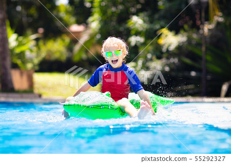 Child in swimming pool. Kid on inflatable float 55292327