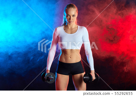confident sexy woman in sporty clothes pumping up muscles confident sexy woman in sporty clothes pumping up muscles 55292655