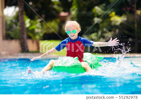 Child in swimming pool. Kid on inflatable float 55292978