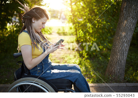 cheerful fashion girl spending time with her mobile phone 55293043