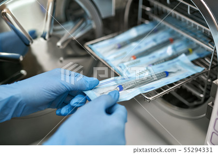 Dentist is taking dental probe from sterilize machine 55294331