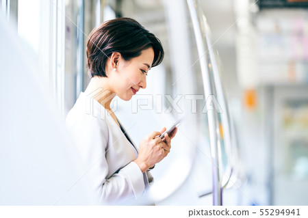 Business woman smartphone train photography cooperation "Keio Electric Railway Co., Ltd." Business woman smartphone train photography cooperation "Keio Electric Railway Co., Ltd." 55294941