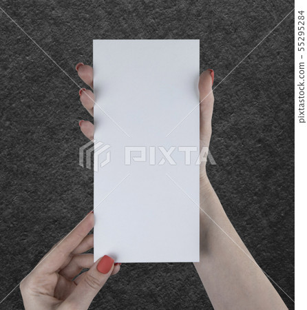 A woman holding white booklet A woman holding white booklet 55295284