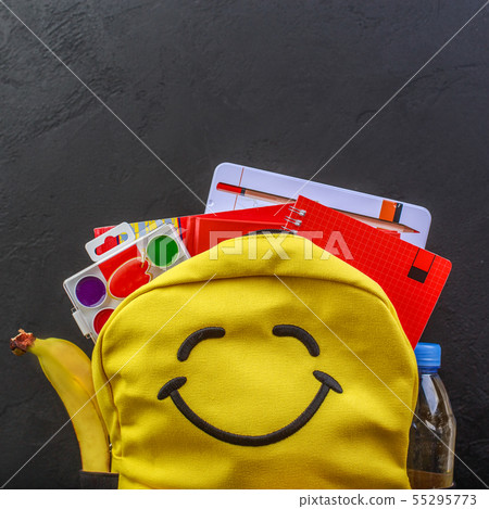 Yellow school backpack with accessories on black background 55295773