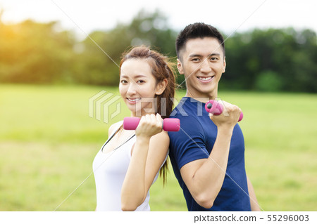 asian young couple training with dumbbells 55296003