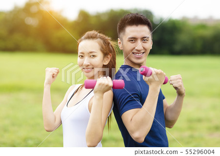 asian young couple training with dumbbells 55296004