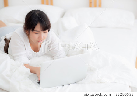 Beautiful asian woman smile lying work laptop Beautiful asian woman smile lying work laptop 55296555