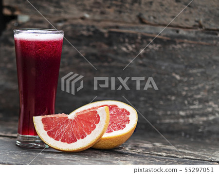 Grapefruit  juice  on wooden background 55297051