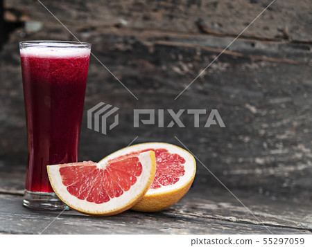 Grapefruit juice on wooden background Grapefruit juice on wooden background 55297059