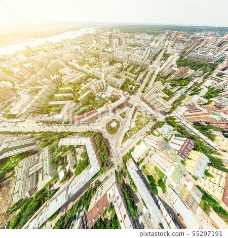Aerial city view with crossroads and roads, houses, buildings, parks and parking lots. Sunny summer Aerial city view with crossroads and roads, houses, buildings, parks and parking lots. Sunny summer 55297191