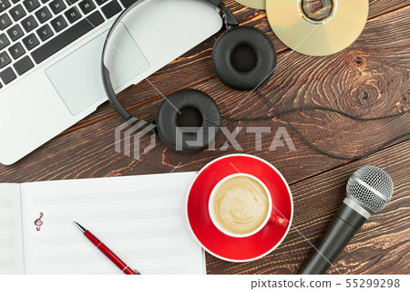 Wooden background with laptop and audio devices. Wooden background with laptop and audio devices. 55299298