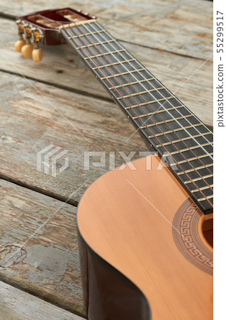 Guitar on wooden background, cropped image. 55299517