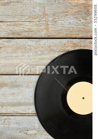 Vinyl record on old wooden background. 55299608