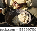 Indian man rolls dough balls samosa for breakfast 55299750